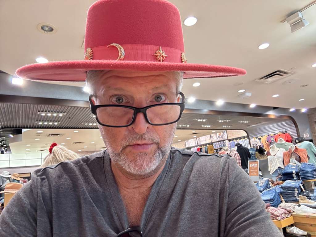 Kenneth Holland wears pink hat at Buckle Jeans store at Northeast Mall in Hurst, Texas